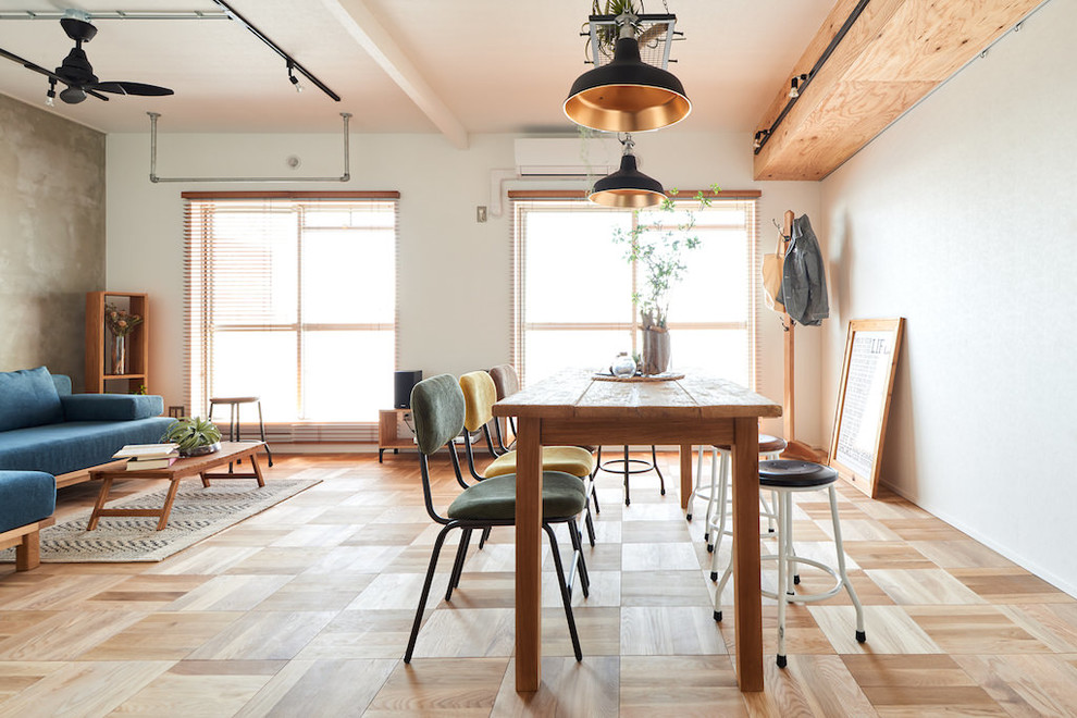 Idée de décoration pour une salle à manger design avec un sol en bois brun, un mur blanc et un sol marron.