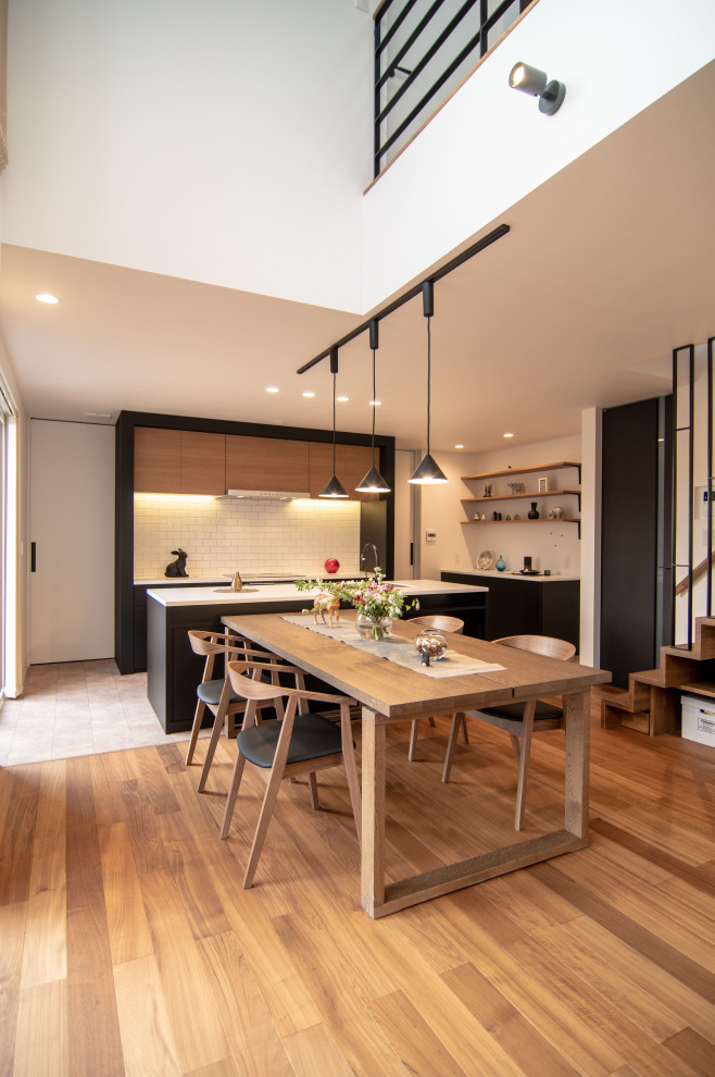 Ispirazione per una sala da pranzo aperta verso la cucina contemporanea con pareti bianche, pavimento in legno massello medio e pavimento beige