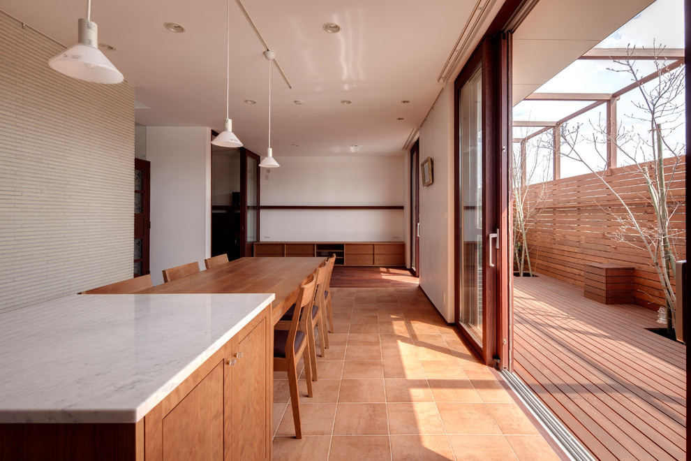 Photo of a retro open plan dining room in Tokyo Suburbs with white walls, terracotta flooring and brown floors.