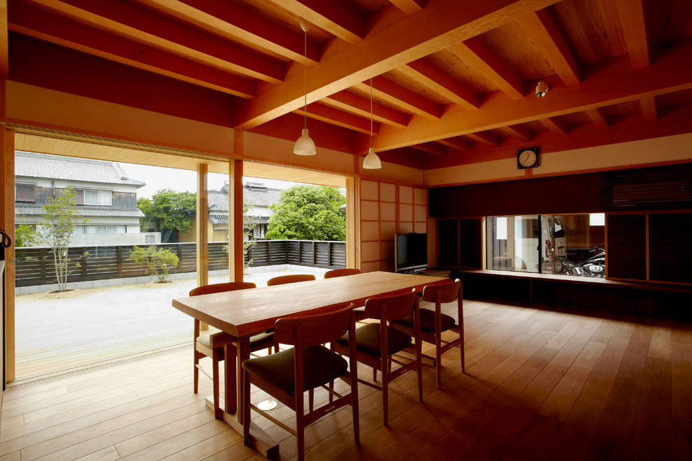 Modelo de comedor asiático abierto con paredes blancas, suelo de madera en tonos medios y suelo multicolor