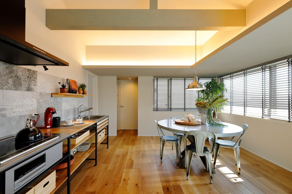 Große Moderne Wohnküche ohne Kamin mit grauer Wandfarbe, braunem Holzboden und braunem Boden in Sonstige