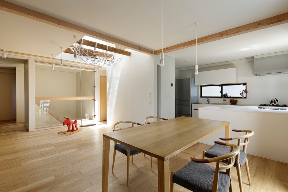 Inspiration for a medium sized scandinavian dining room in Tokyo with white walls, light hardwood flooring and brown floors.