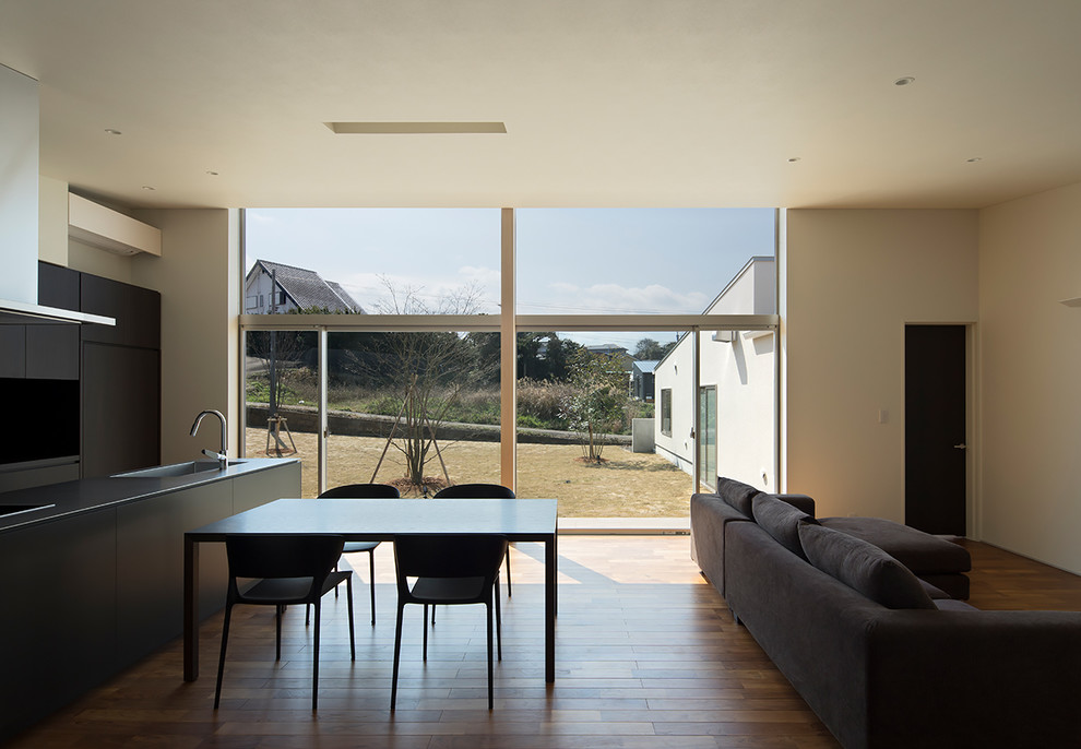 Design ideas for a medium sized modern open plan dining room in Fukuoka with white walls and medium hardwood flooring.