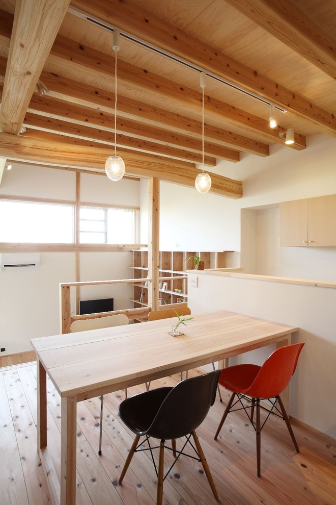 Design ideas for a world-inspired dining room in Nagoya with light hardwood flooring, beige floors and white walls.