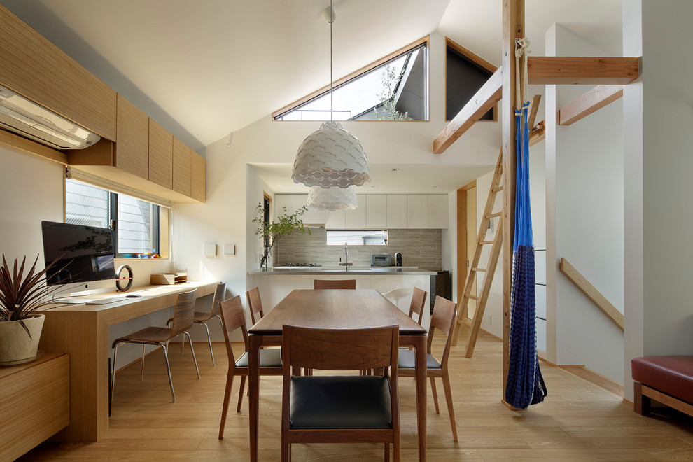 Foto di una piccola sala da pranzo aperta verso il soggiorno nordica con pareti bianche, pavimento in legno massello medio e pavimento marrone