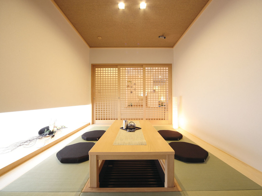 Exemple d'une salle à manger asiatique fermée avec un mur blanc, un sol de tatami et un sol vert.