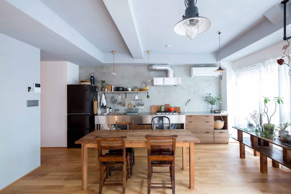 Design ideas for an industrial open plan dining room in Tokyo with light hardwood flooring, a timber clad ceiling, tongue and groove walls and brown floors.