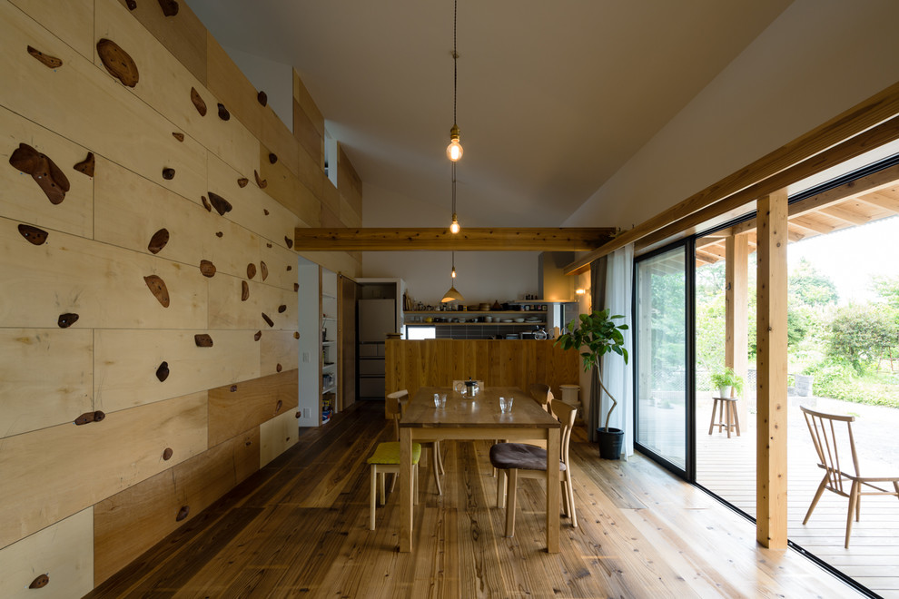 Idee per una sala da pranzo aperta verso il soggiorno etnica con pareti multicolore, pavimento in legno massello medio e pavimento marrone