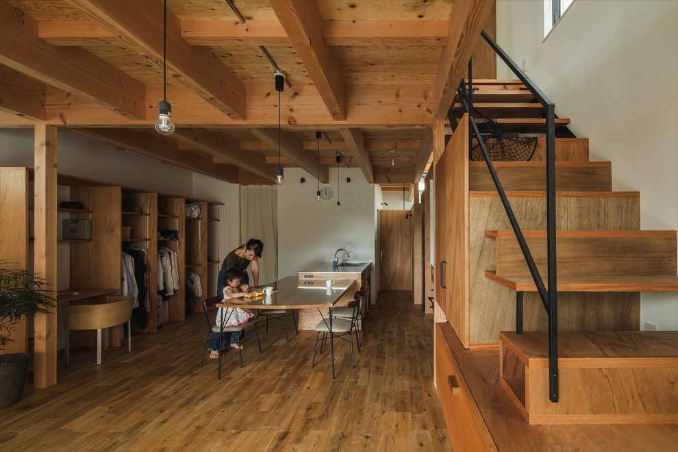 Example of a small mountain style medium tone wood floor and beige floor great room design in Other with white walls