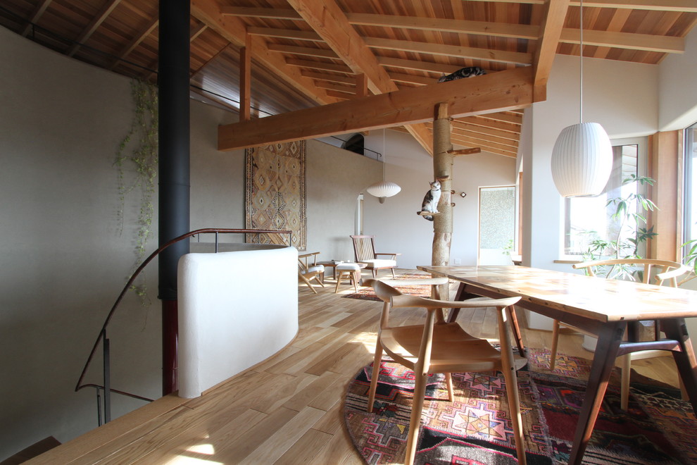 Example of a zen light wood floor and brown floor dining room design in Sapporo with multicolored walls