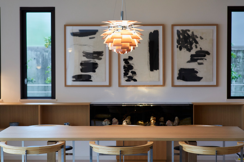 This is an example of a world-inspired open plan dining room in Tokyo Suburbs with white walls.