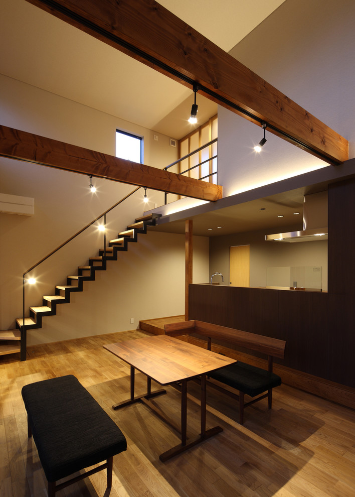 Large world-inspired open plan dining room in Other with white walls, medium hardwood flooring and brown floors.