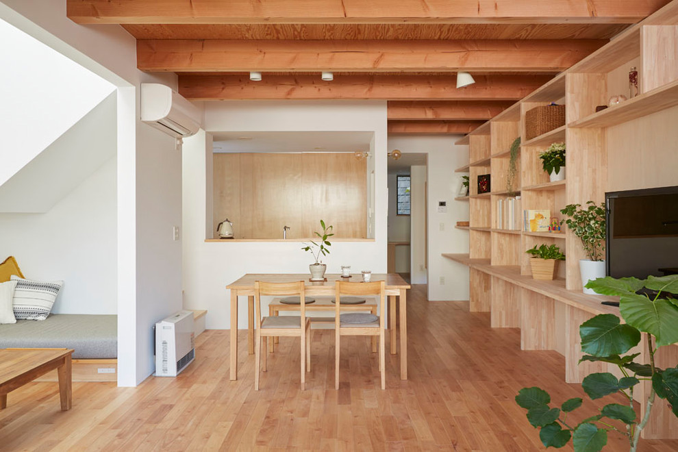 Photo of a world-inspired open plan dining room in Yokohama with white walls, medium hardwood flooring and brown floors.