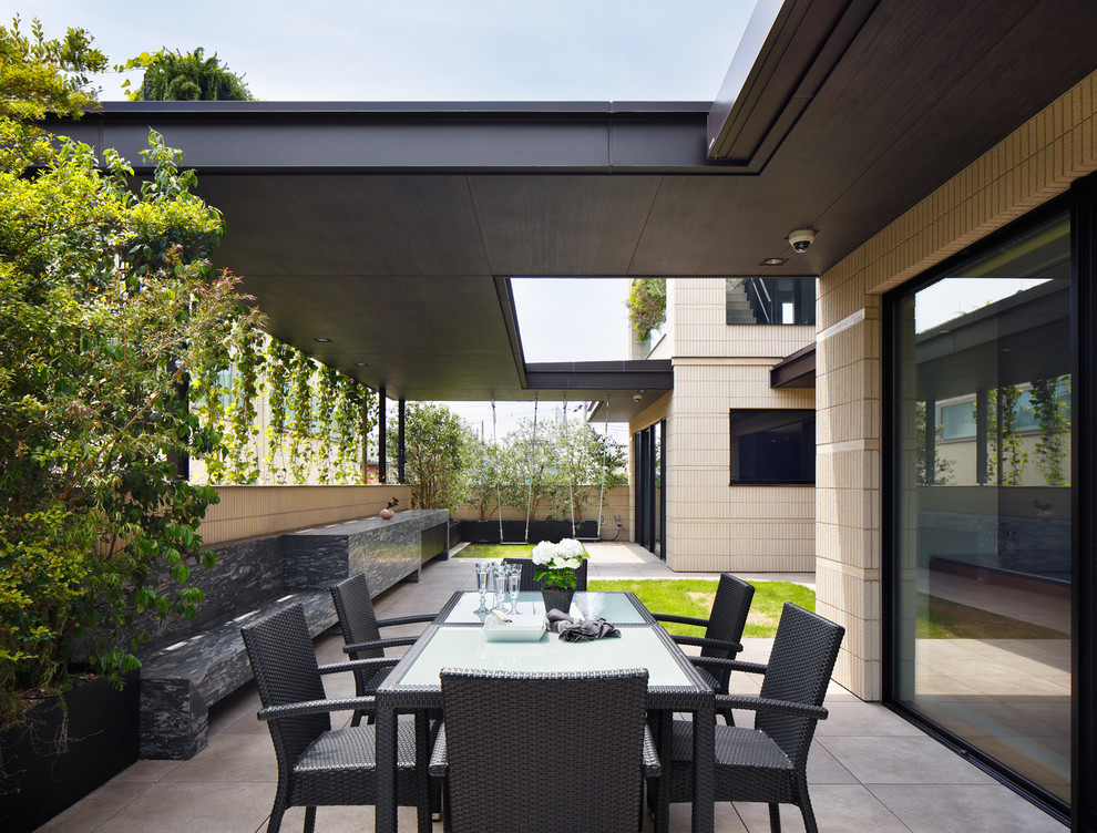 Immagine di un patio o portico moderno con un tetto a sbalzo