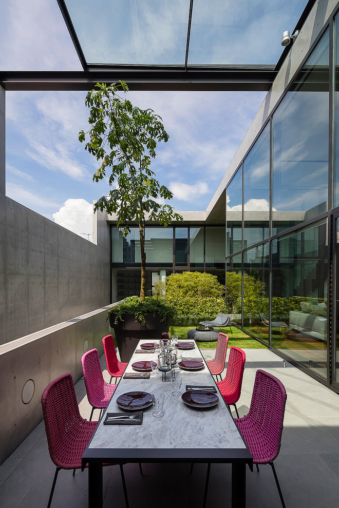 Cette image montre une terrasse latérale minimaliste avec un auvent.