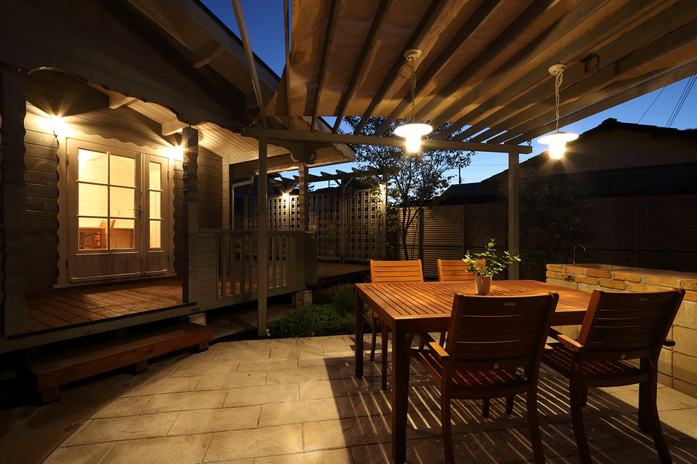 Example of a cottage patio design in Other