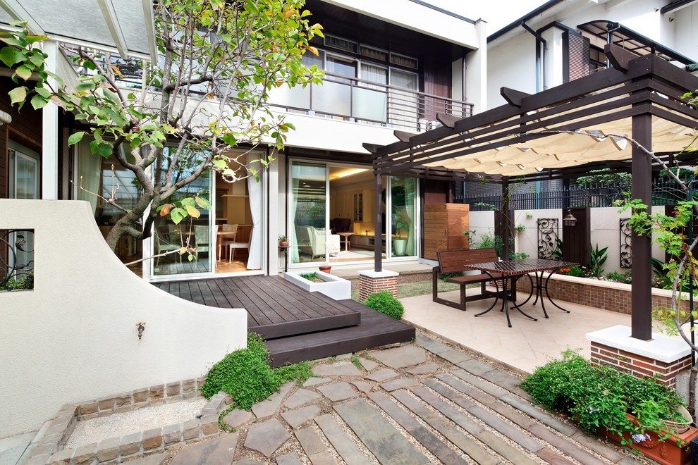 Victorian back patio in Osaka with decking and a pergola.