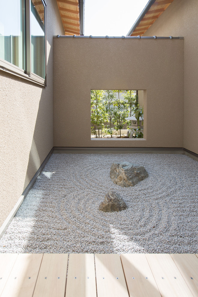 Small world-inspired courtyard patio in Other with gravel and no cover.