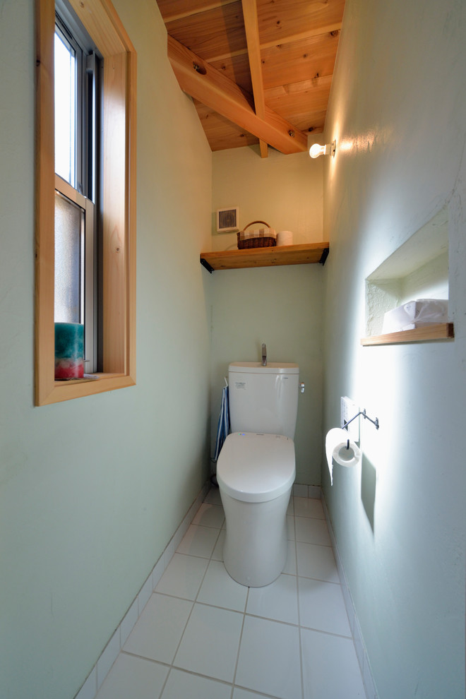 World-inspired cloakroom in Other with blue walls and white floors.