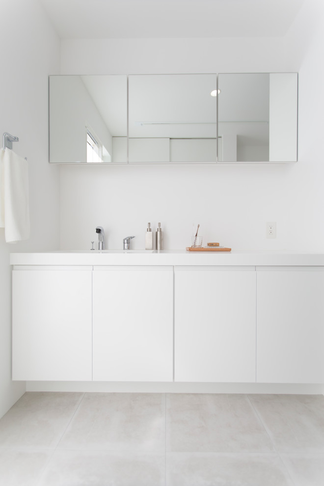他の地域にある広い北欧スタイルのおしゃれなトイレ・洗面所 (白い壁、白い洗面カウンター) の写真