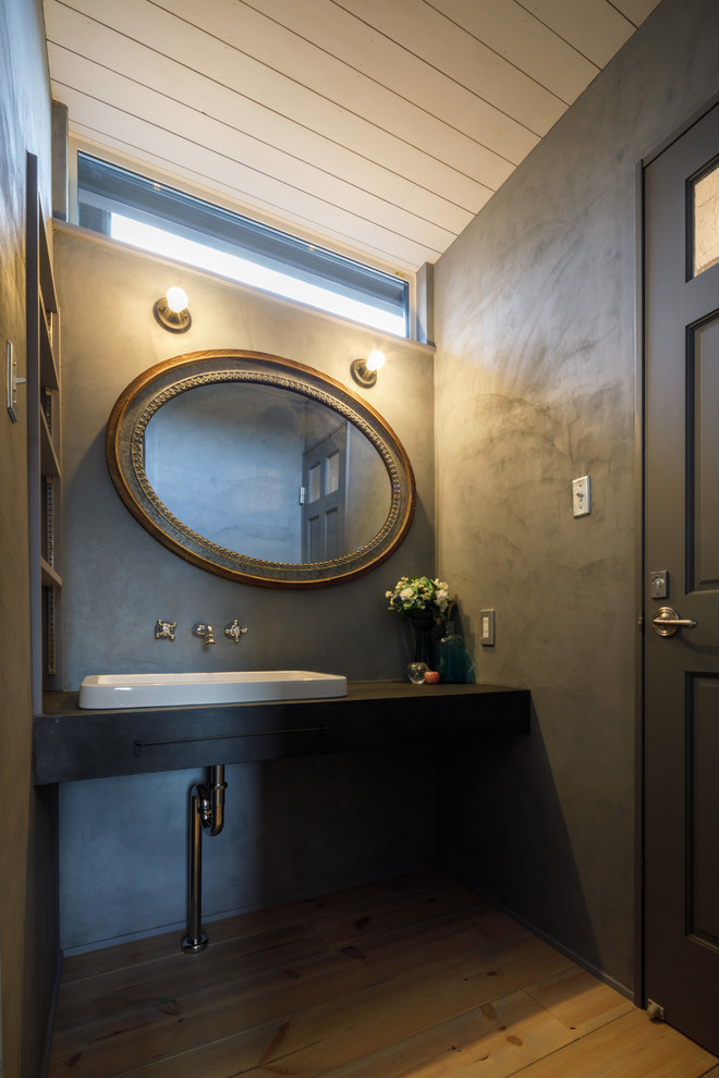 Example of an urban powder room design in Other