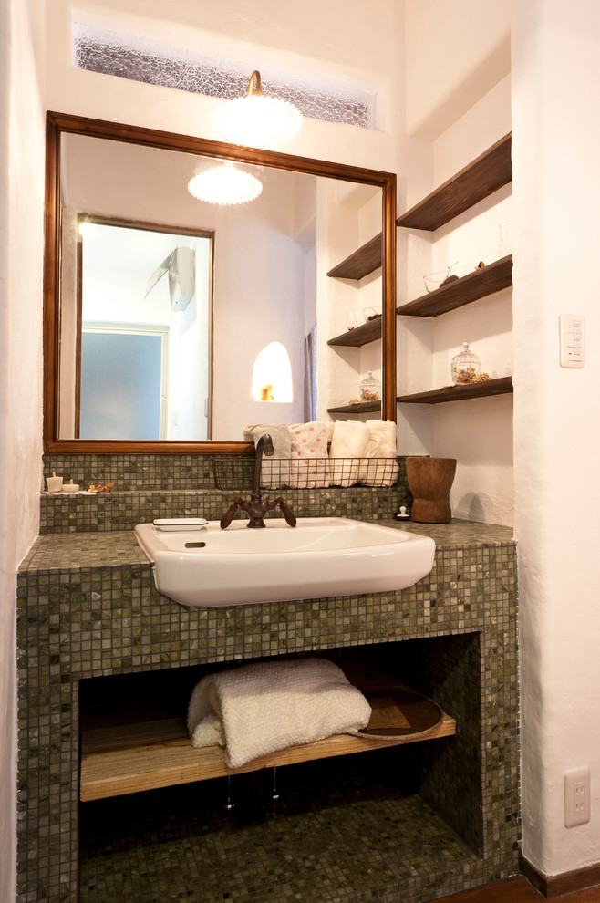 Design ideas for a small mediterranean cloakroom in Fukuoka with blue tiles, porcelain tiles, tiled worktops, blue worktops, white walls, medium hardwood flooring, a built-in sink and brown floors.