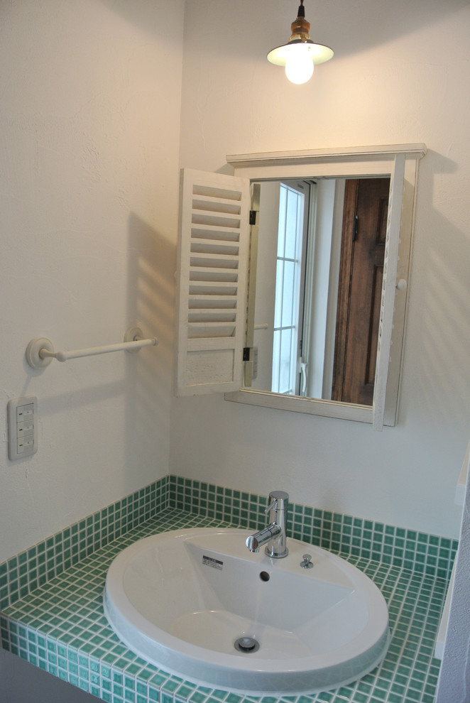Design ideas for a small rural cloakroom in Nagoya with white walls, a built-in sink, tiled worktops and mosaic tiles.