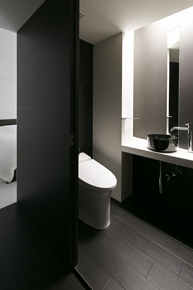 Inspiration för moderna toaletter, med vita väggar, mörkt trägolv och ett fristående handfat