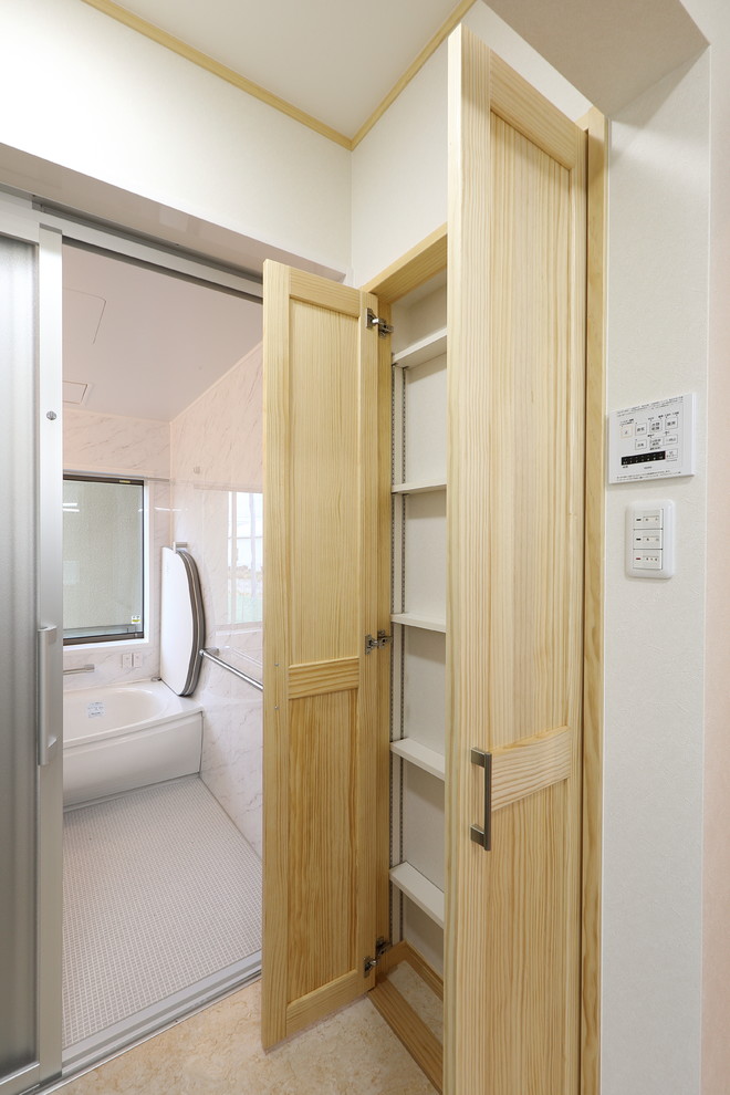 Imagen de aseo de tamaño medio con armarios tipo mueble, puertas de armario de madera clara, paredes blancas, suelo de contrachapado y suelo beige