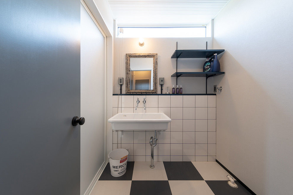 Design ideas for an industrial cloakroom in Other with white walls, a console sink and multi-coloured floors.
