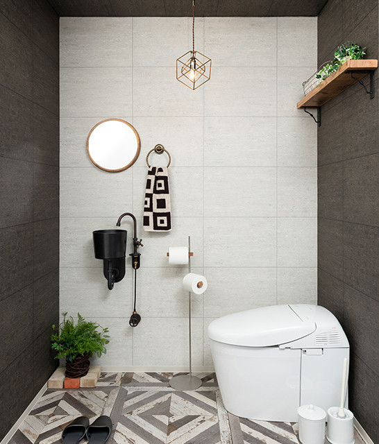 Inspiration for a small industrial brown floor powder room remodel in Other with a one-piece toilet, black walls, a wall-mount sink and black countertops