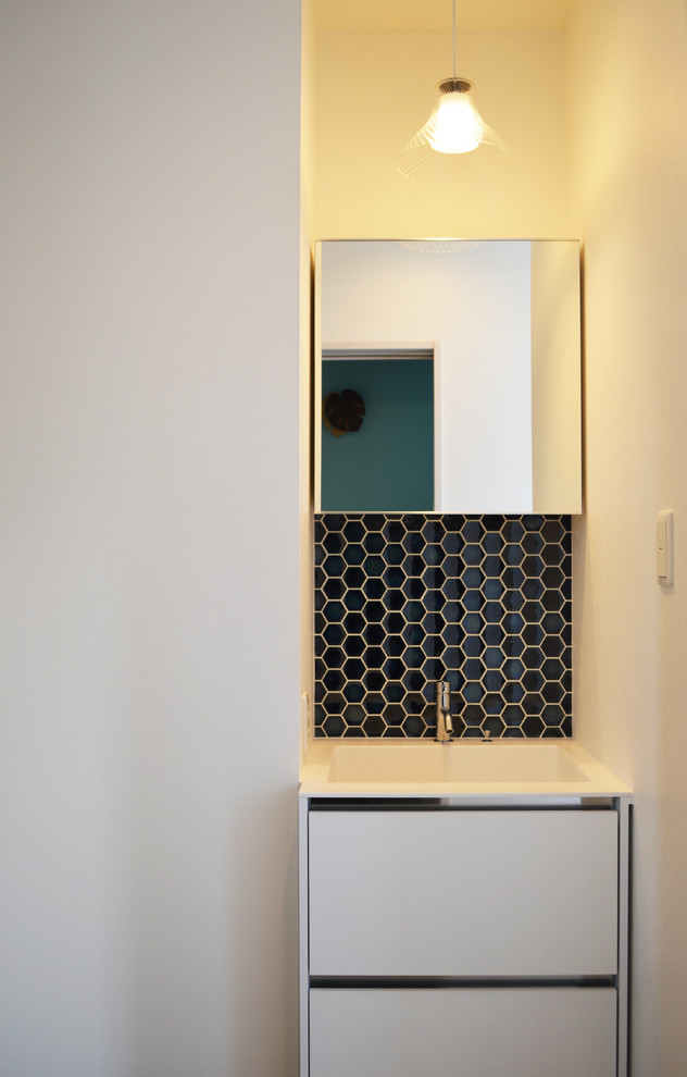 Photo of a scandinavian cloakroom in Other with black tiles.