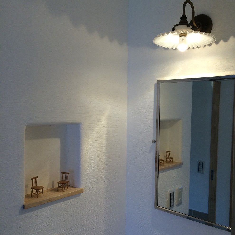 他の地域にある小さなトラディショナルスタイルのおしゃれなトイレ・洗面所 (白い壁、造り付け洗面台) の写真