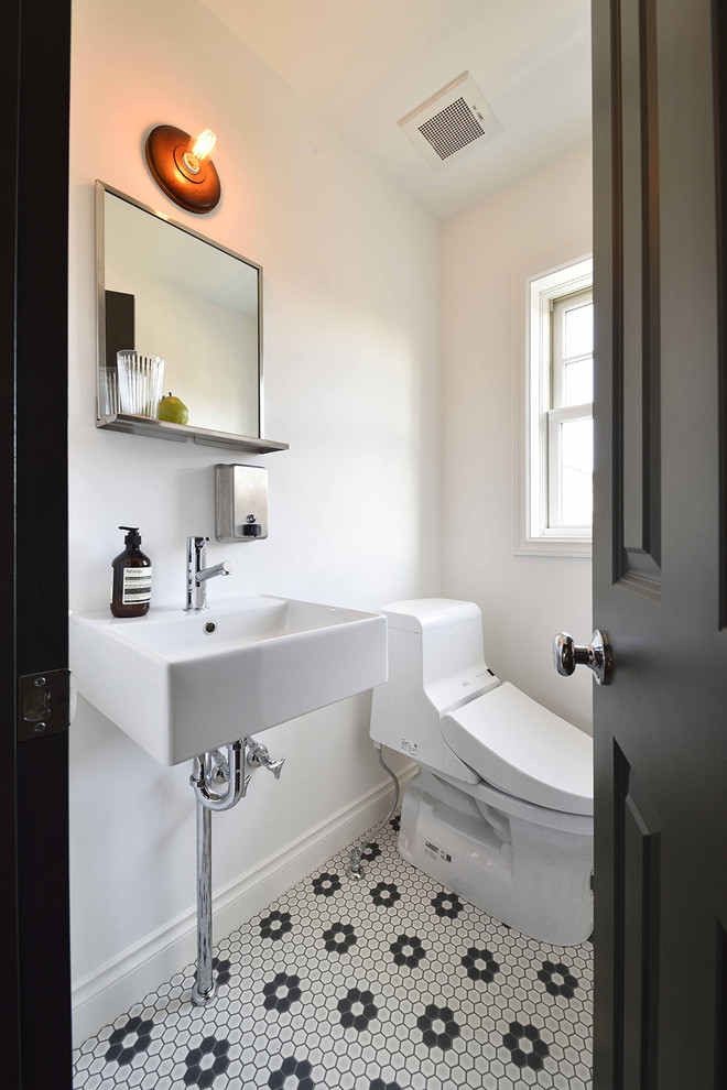 На фото: туалет в стиле ретро с белыми стенами, полом из керамогранита, подвесной раковиной и разноцветным полом с