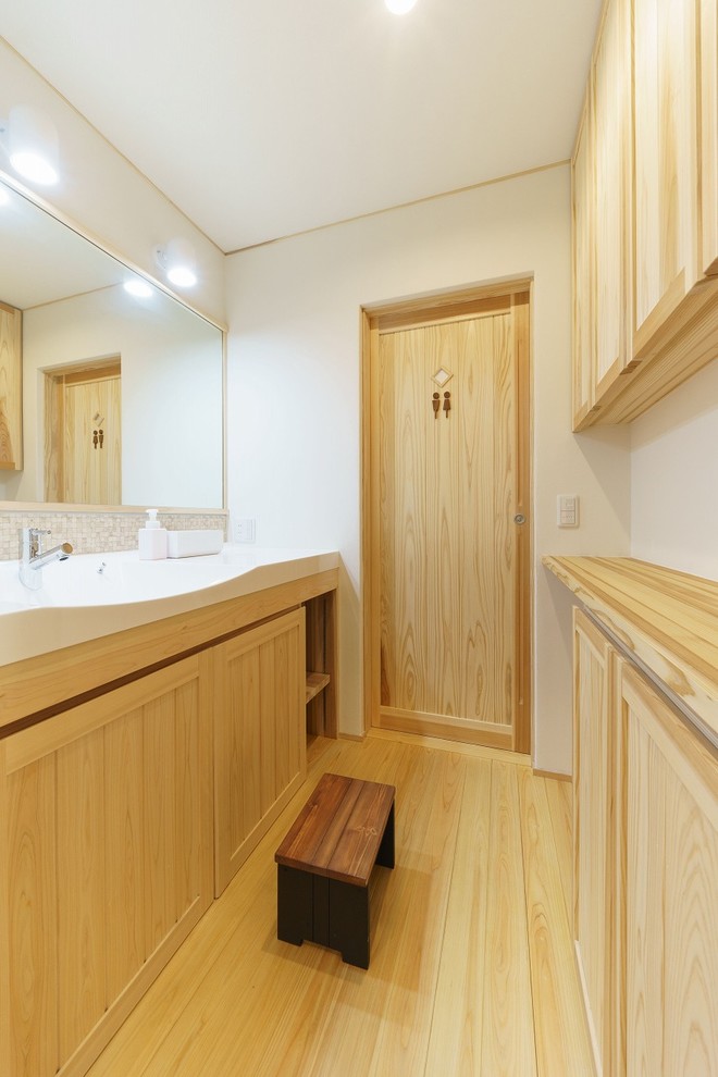 This is an example of a world-inspired cloakroom in Other with solid surface worktops and white worktops.