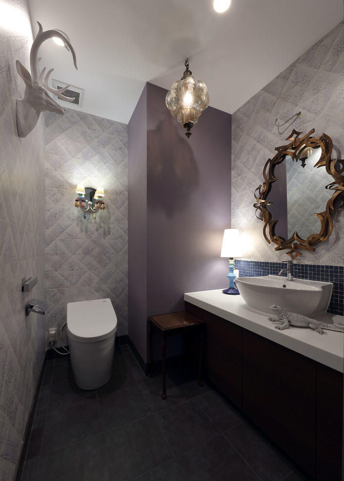 Inredning av ett eklektiskt toalett, med lila väggar och ett fristående handfat