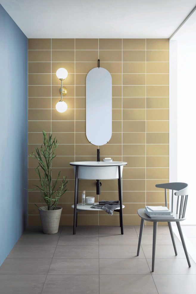 На фото: туалет в стиле модернизм с желтой плиткой, керамической плиткой, желтыми стенами, полом из керамической плитки, серым полом и напольной тумбой с