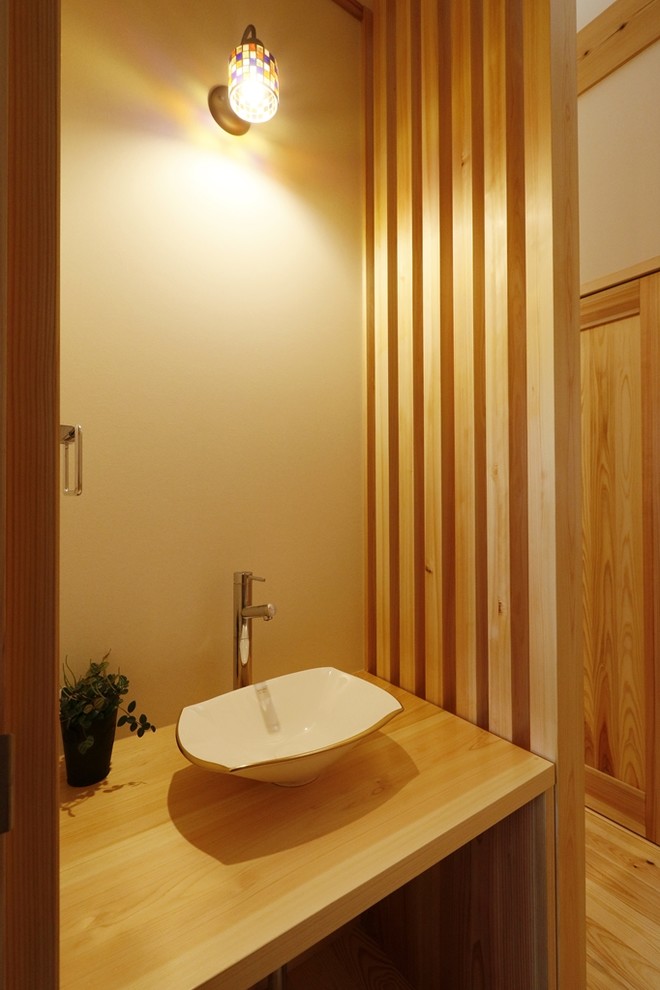 Inspiration for a world-inspired cloakroom in Other with wooden worktops.