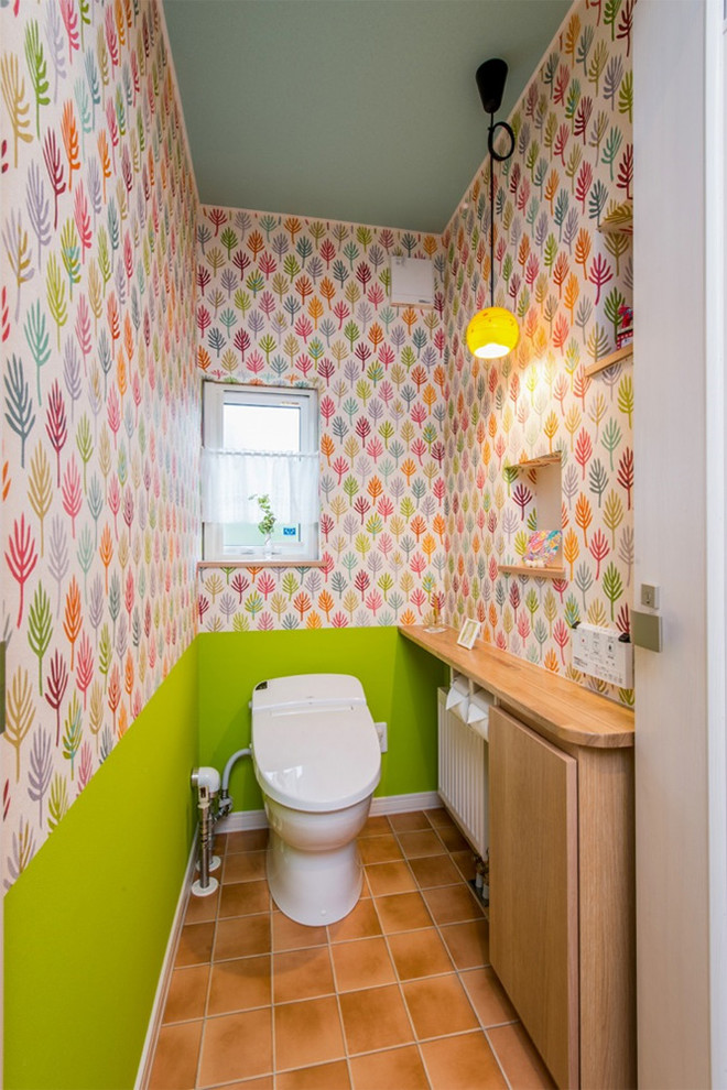 東京23区にある小さなおしゃれなトイレ・洗面所 (オレンジの床) の写真