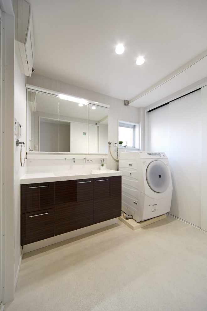 This is an example of a modern cloakroom in Kobe with brown cabinets, white walls, white floors and white worktops.