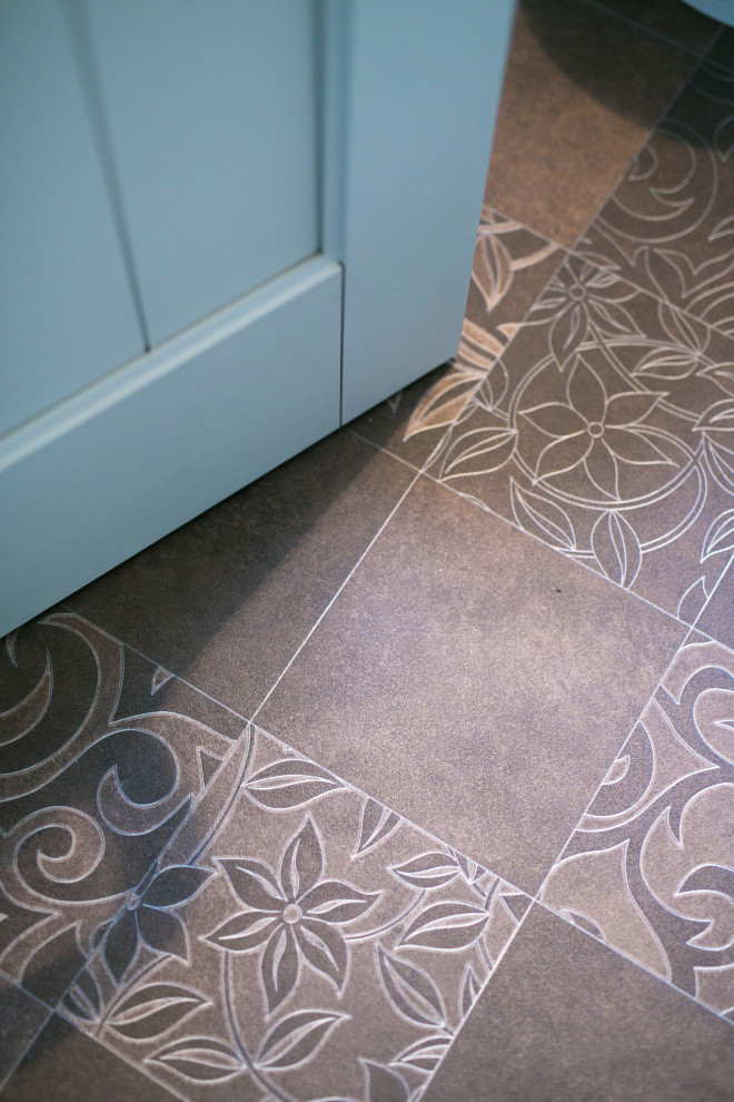 Example of a small danish vinyl floor and brown floor powder room design in Other