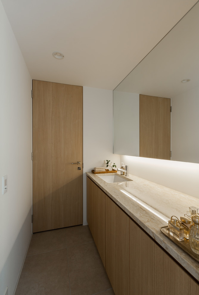 名古屋にあるコンテンポラリースタイルのおしゃれなトイレ・洗面所 (白い壁、一体型シンク、ベージュの床) の写真