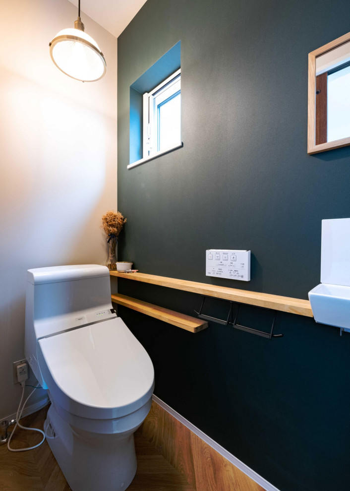 This is an example of a contemporary cloakroom in Fukuoka with medium wood cabinets, white tiles, black walls and white worktops.