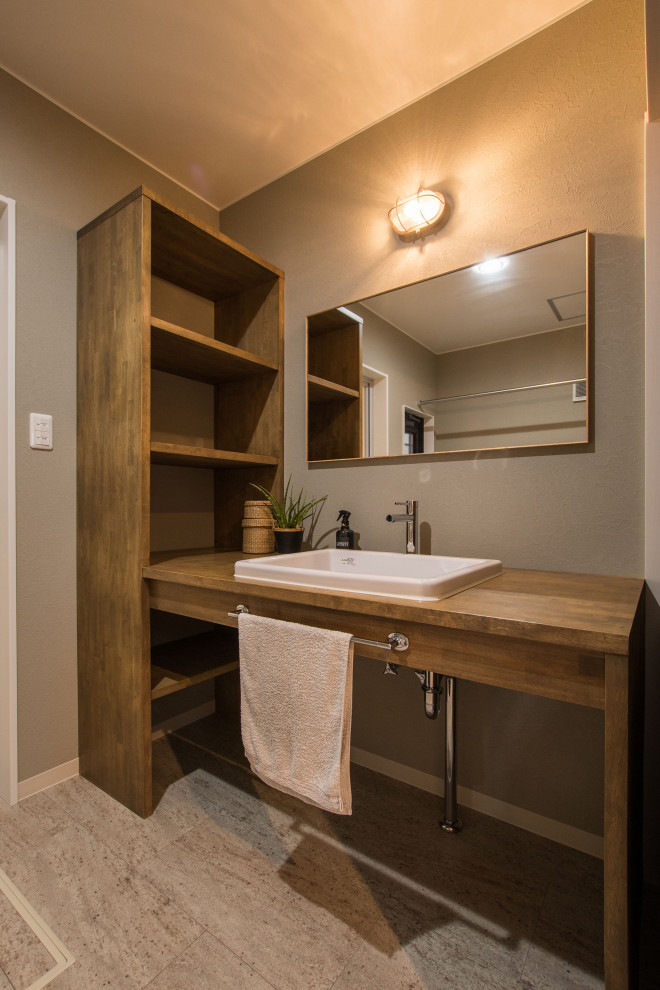 Aménagement d'un petit WC et toilettes industriel en bois brun avec un mur gris, un lavabo encastré, un plan de toilette en bois, un sol beige, un plan de toilette blanc, meuble-lavabo encastré, un plafond en papier peint et du papier peint.
