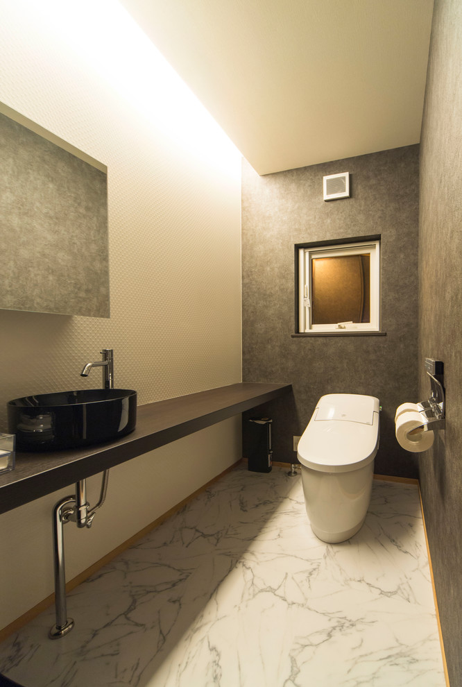 他の地域にあるモダンスタイルのおしゃれなトイレ・洗面所 (マルチカラーの壁、ベッセル式洗面器、白い床) の写真