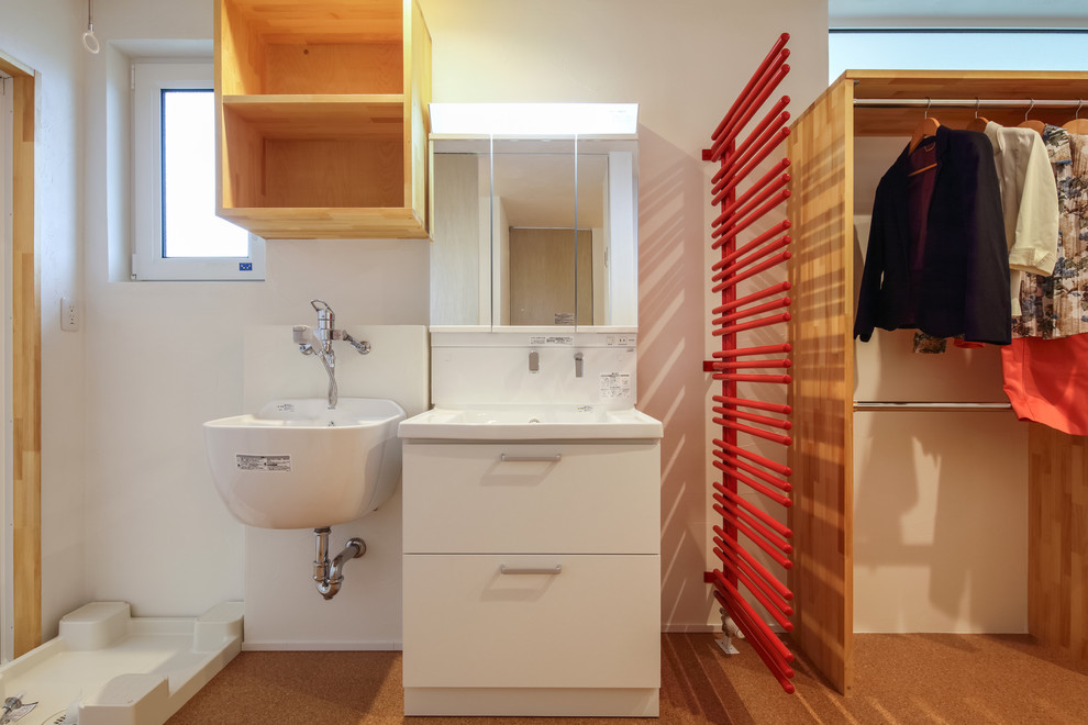 Design ideas for a medium sized world-inspired cloakroom in Other with beaded cabinets, medium wood cabinets, a one-piece toilet, white walls, cork flooring, an integrated sink, wooden worktops, orange floors and white worktops.