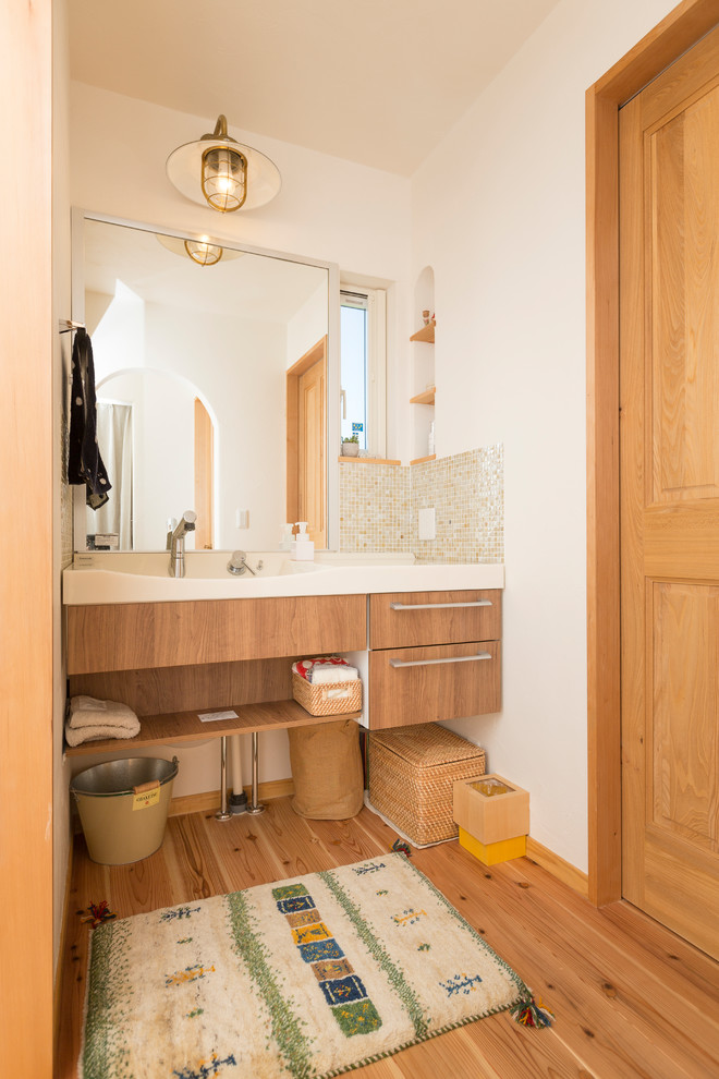 Idéer för ett asiatiskt toalett, med släta luckor, bruna skåp, vita väggar, mellanmörkt trägolv och brunt golv