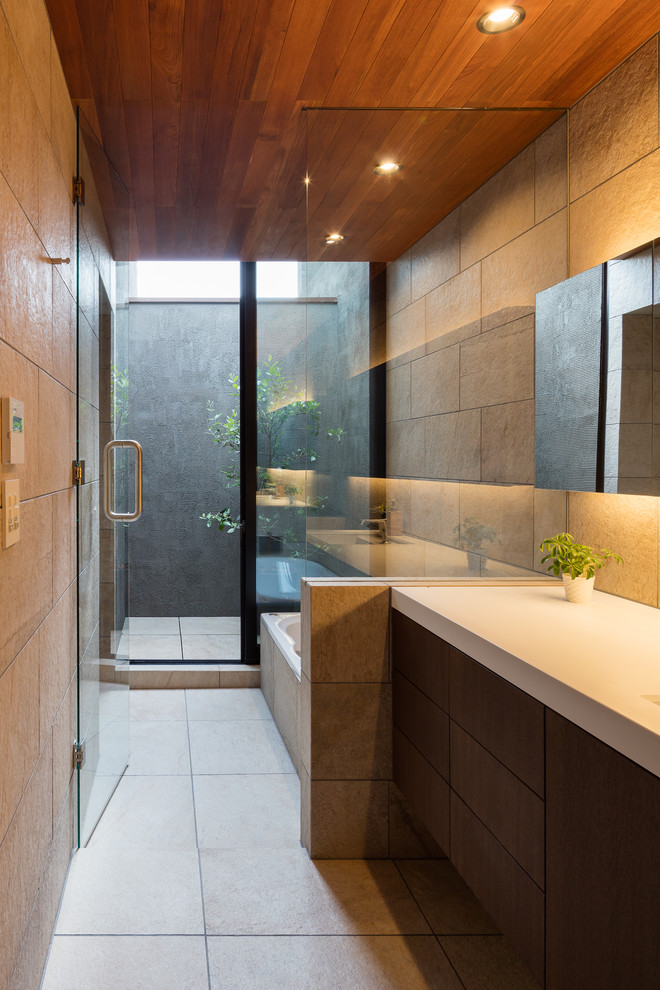 Inredning av ett modernt badrum, med beige väggar, ett integrerad handfat och beiget golv