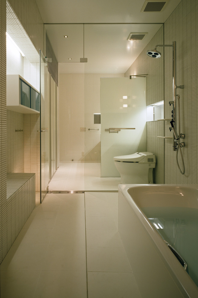 World-inspired bathroom in Osaka with white tiles, white walls and white floors.