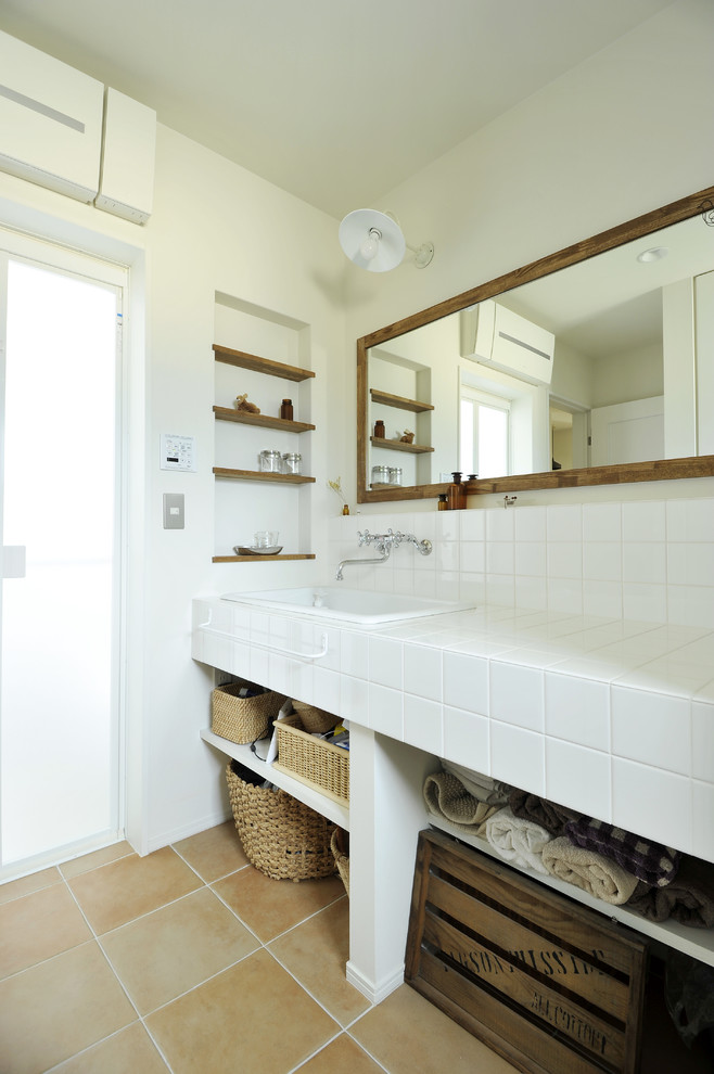 Inspiration for a cloakroom in Other with open cabinets, white walls, vinyl flooring, a submerged sink, tiled worktops and beige floors.